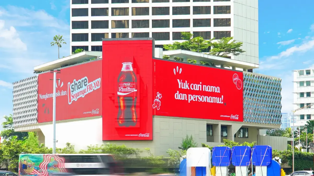 LED Mandarin at Bundaran HI in daylight, showing Coca-Cola artwork that wraps across its left, centre and right faces