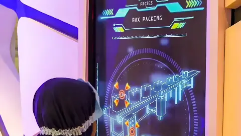 Child playing a Chocolatos portrait touchscreen game showing a box-packing process at a Garudafood activation