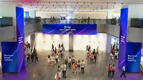 LED pillar screens and a long LED strip in the atrium of Agora Lifestyle Mall, Tanah Abang, Central Jakarta, with shoppers walking below